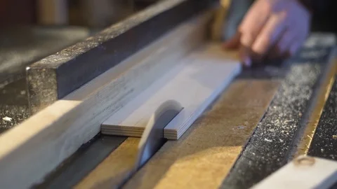 The carpenter saws the boards on a circular saw. Carpentry workshop Видео 107611302