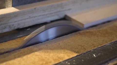 The carpenter saws the boards on a circular saw. Carpentry workshop Video stock 107611399