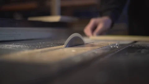 The carpenter saws the boards on a circular saw. Carpentry workshop Video stock 107612644
