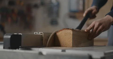 Carpenter saws logs on a circular saw in his workshop, making of the planks Stock Footage 149274585