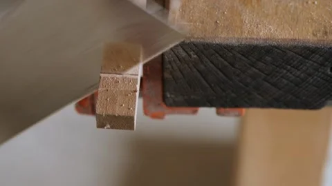 A carpenter saws a piece from a oak board using a hand saw for wood Stock Footage 156683519
