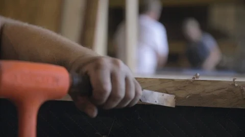 Carpenter scraping off extra wood with a chisel Stock Footage 87612140