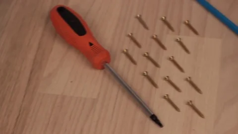 Carpenter screwing the crew with cordless screwdriver into wooden board Stock Footage 75149793