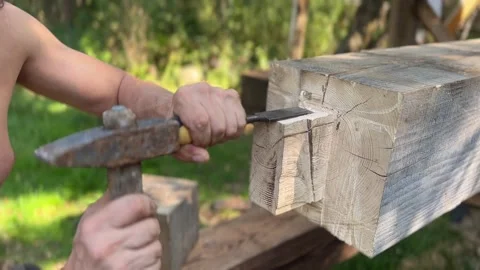 Carpenter shapes wood with chisel Stock Footage 283545148