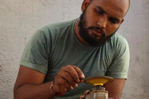 A Carpenter sharp his equipment with machine Stock Photos