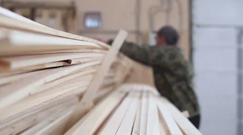 Carpenter shifts the timbers in the stack Stock Footage 59781557