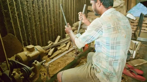 Carpenter skillfully operates lathe to shape timber Stock Footage 304851609