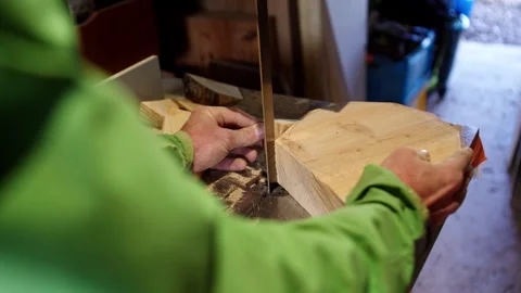 Carpenter skillfully shapes wood using hands and tools in workshop Stock Footage 321385743