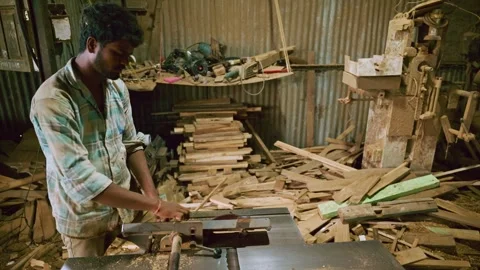Carpenter slices timber block using electric saw Stock Footage 313671358