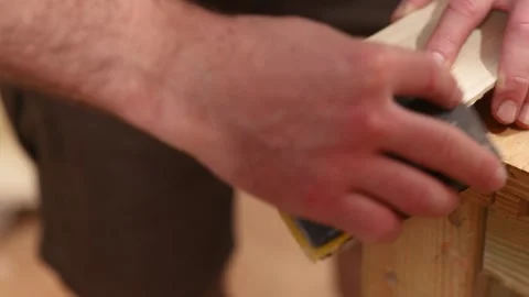 Carpenter smoothing wooden plank using sandpaper 動画素材 314045861