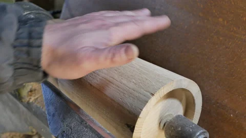 Carpenter is spinning the blank with his hand. Stock Footage 150859987