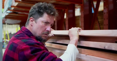 Carpenter Stacking Lumber in a Workshop 스톡 동영상 323778550