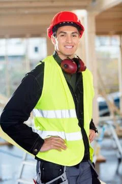 Carpenter Standing With Hands On Hips At Construction Site Foto stock
