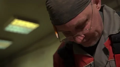 Carpenter stands behind workplace, processes wood using specialized equipment Stock Footage 149122600