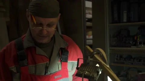 Carpenter stands behind workplace, processes wood using specialized equipment Stock Footage 149122920