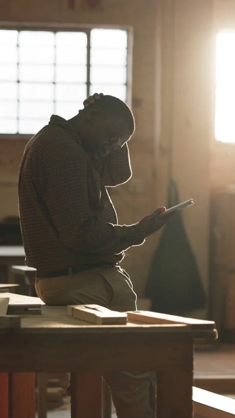 Carpenter, stress and black man on tablet in workshop for bad news, delay and Stock Footage 343842379