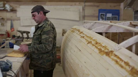 Carpenter studies the draft of the boat at the shipyard Stock Footage 59782490