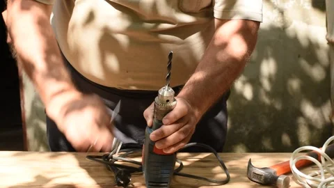 The carpenter on the table is working with a drill. 스톡 동영상 246486051
