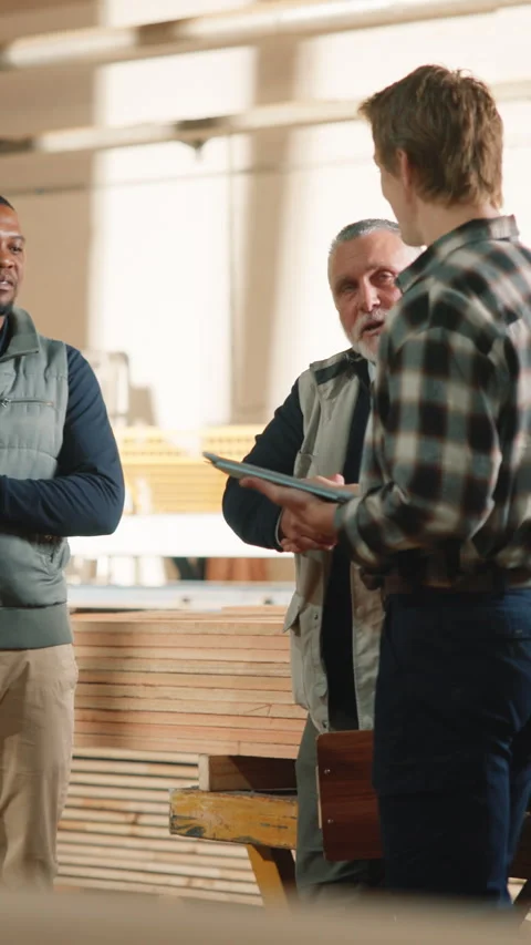 Carpenter, tablet and handshake in workshop with people, timber manufacturing Stock Footage 344370744
