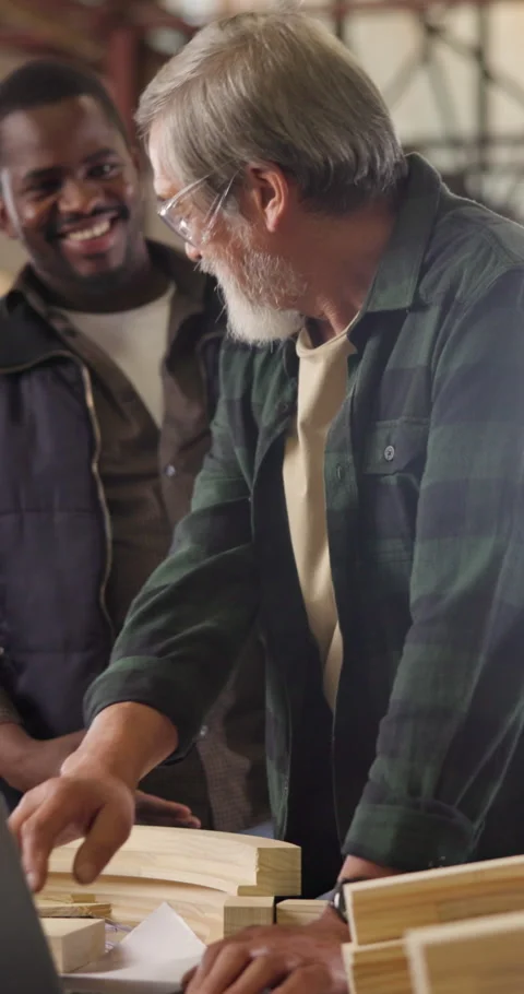 Carpenter, team and handshake in workshop with laptop, partnership or impress Stock Footage 340982220