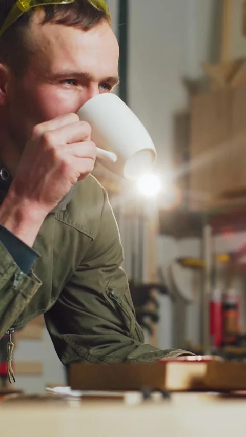 The carpenter is thinking about developing his business and drinking coffee Video stock 305236383