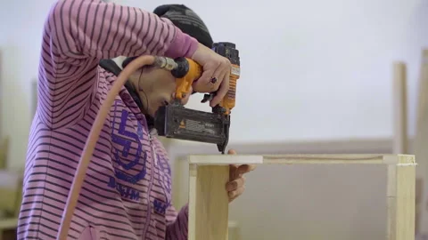 Carpenter tighten screws using an electric drill screwdriver, slow motion Video stock 141165094