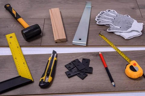 Carpenter tools on laminated flooring Stock Photos