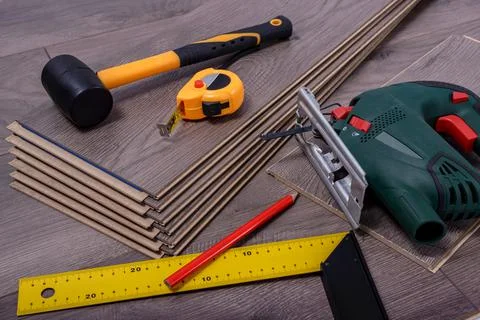 Carpenter tools on laminated flooring Stock Photos