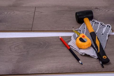 Carpenter tools on laminated flooring Stock Photos
