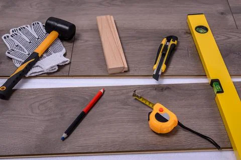 Carpenter tools on laminated flooring Stock Photos