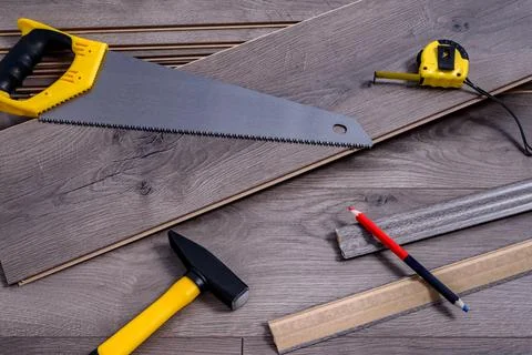 Carpenter tools on laminated flooring Stock Photos