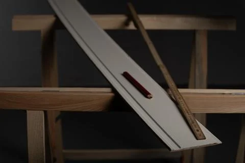 Carpenter tools measuring and marking wooden trim board before cutting Stock Photos