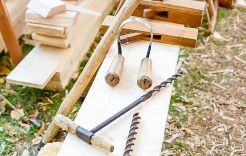 Carpenter tools scraper and drill on planks traditional fixture Stock Photos