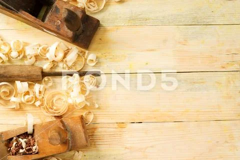 Carpenter tools on wooden table with sawdust. Stock Photos