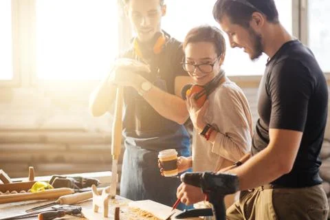 Carpenter Training Female Apprentice To Use Plane Stock Photos