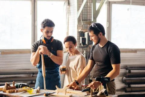 Carpenter Training Female Apprentice To Use Plane Stock Photos