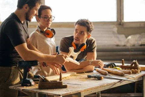 Carpenter Training Female Apprentice To Use Plane Stock Photos