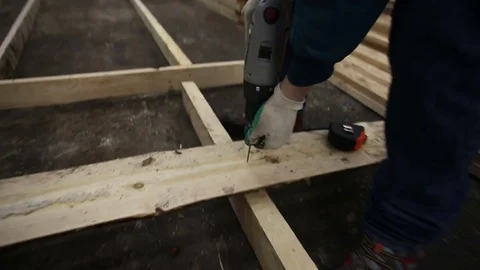 Carpenter twists a nail into a tree close-up Video stock 77203119