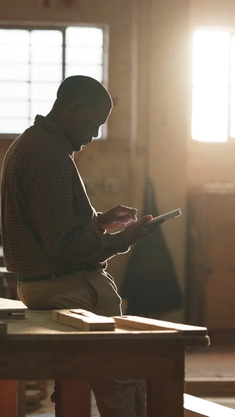 Carpenter, typing and black man on tablet in workshop for planning, report and Stock Footage 343911413