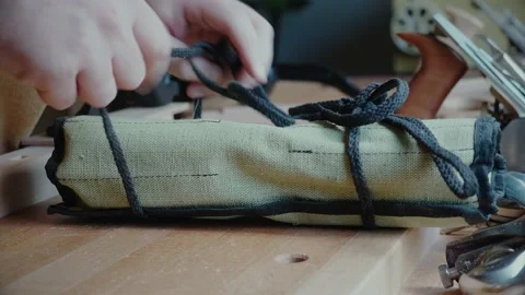 Carpenter unrolls his tools on the table Stock Footage 156499790