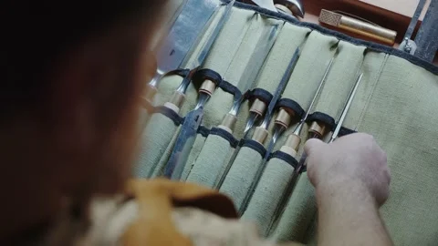 Carpenter unrolls his tools on the table Stock Footage 156499941