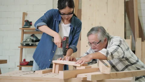 Carpenter use electric drill to drill wood Stock Footage 172039544