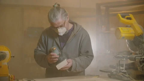 Carpenter use electric sander to polish wooden part of furniture Stock-Footage 138371684