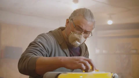 Carpenter use electric sander to polish wooden part of furniture Video stock 138371943