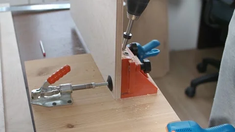 Carpenter use pocket hole jig tool to make strong joints in sheet plywood Stock Footage 237372939