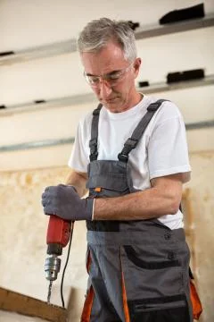 Carpenter used drills  in reparation of old doors Stock Photos
