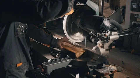 A carpenter uses a cutting saw , to align the edge of the board, furniture manuf Video stock 78437944