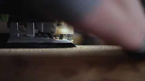 Carpenter uses electric jigsaw to cut wooden board. Wood craftsman working Stock Footage 148271907