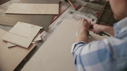 Carpenter uses a grinding machine to align Stock Footage 153494605