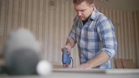 Carpenter uses a grinding machine to align Stock-Footage 153494884